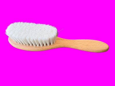 Wooden hairbrush with white bristles o