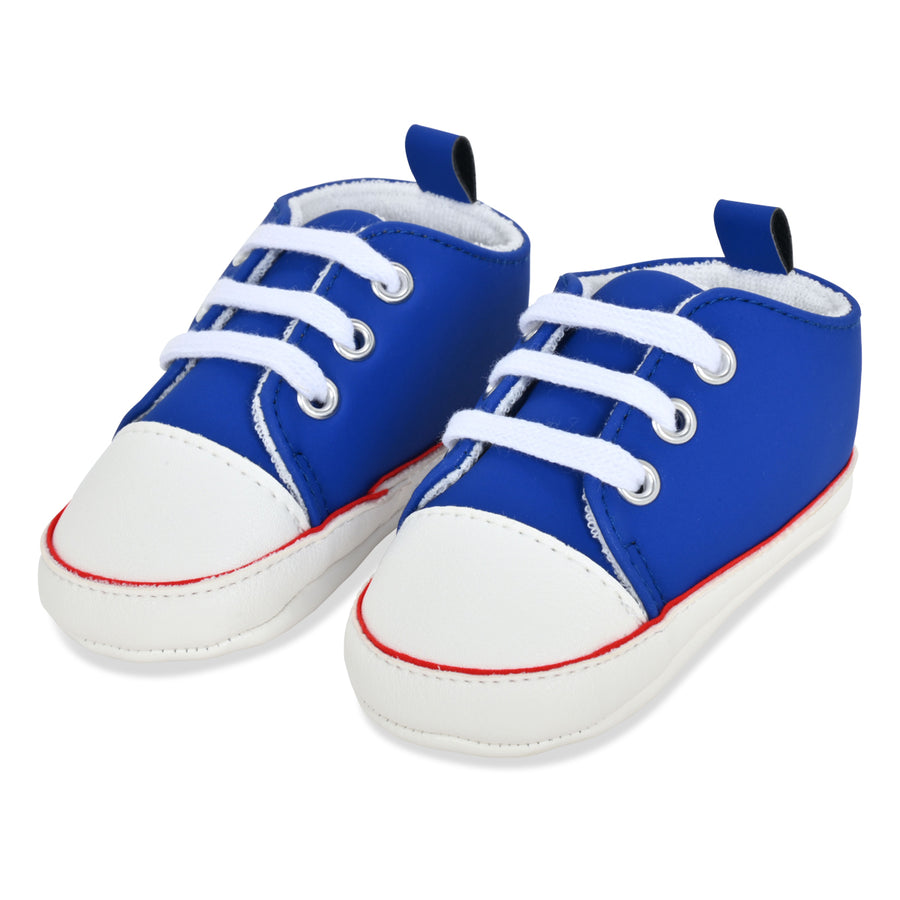 A pair of blue and white crib shoes with red accents and white laces.